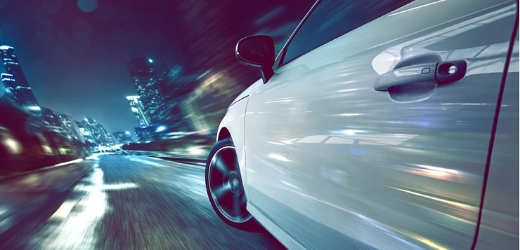 Car driving fast at night