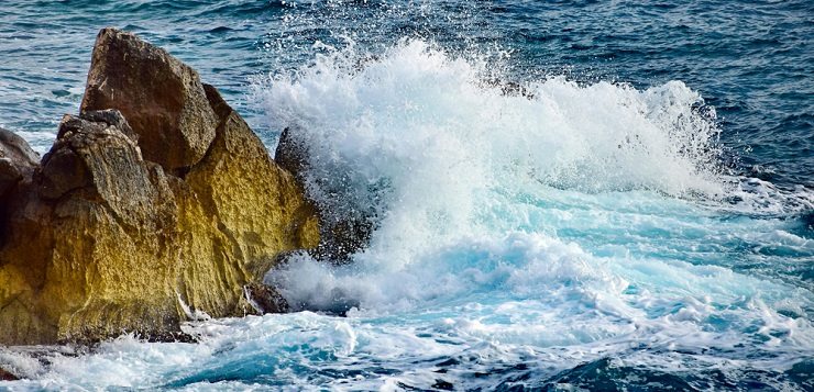 Ocean waves crashing into rock